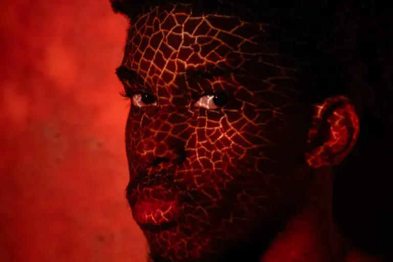 A face with a red background and a pattern over the face.